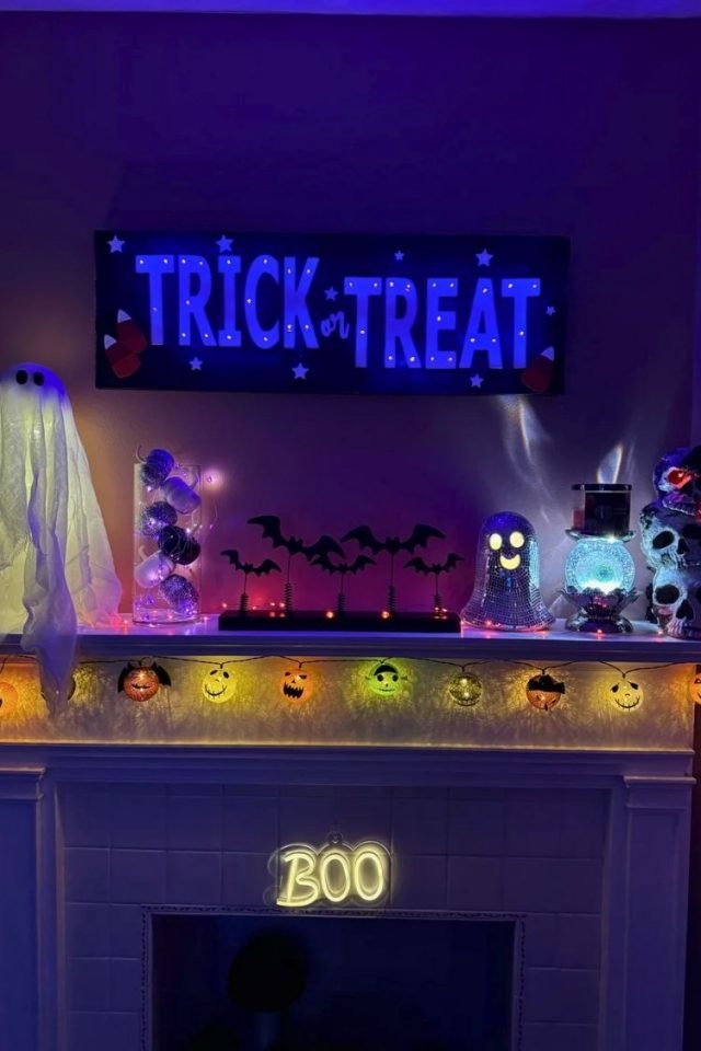 Halloween mantle with TV decorated with pumpkins
