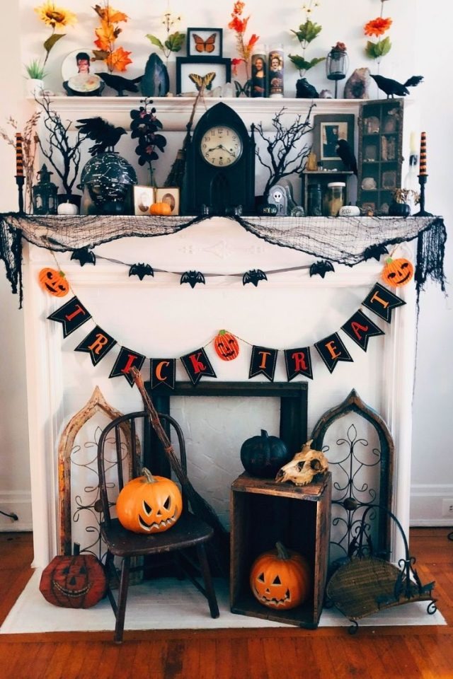 Haunted village miniature setup on mantle with screen